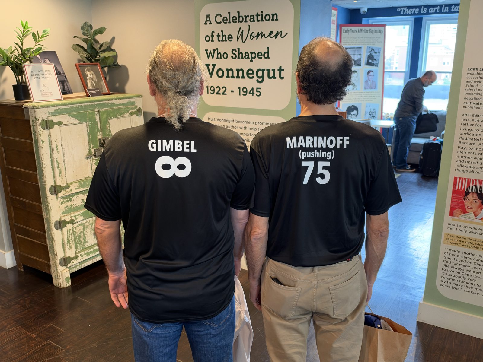 Two attendees in matching black t-shirts reading 